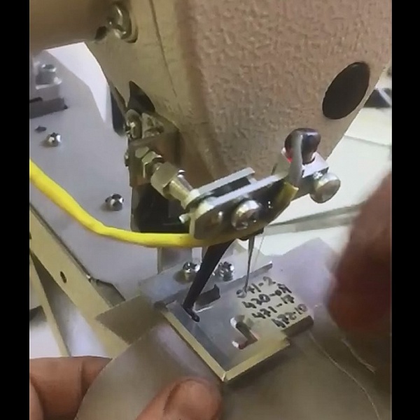 Automated solution for sewing on a metal hanger
