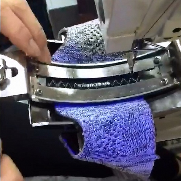 Sewing a tape-label on the tongue of a sneaker using a bartacking machine