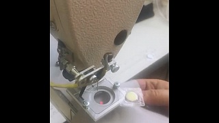 Automated solution for sewing on a laser-marked magnet