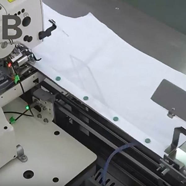 Automated solution for sewing on buttons to a shirt IMB MB 6006A